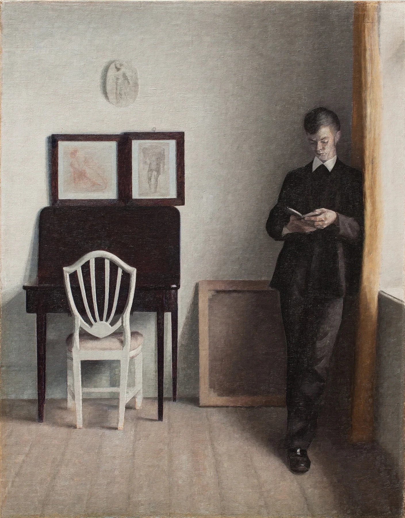 Intérieur avec un jeune homme lisant, peinture de Vilhelm Hammershøi